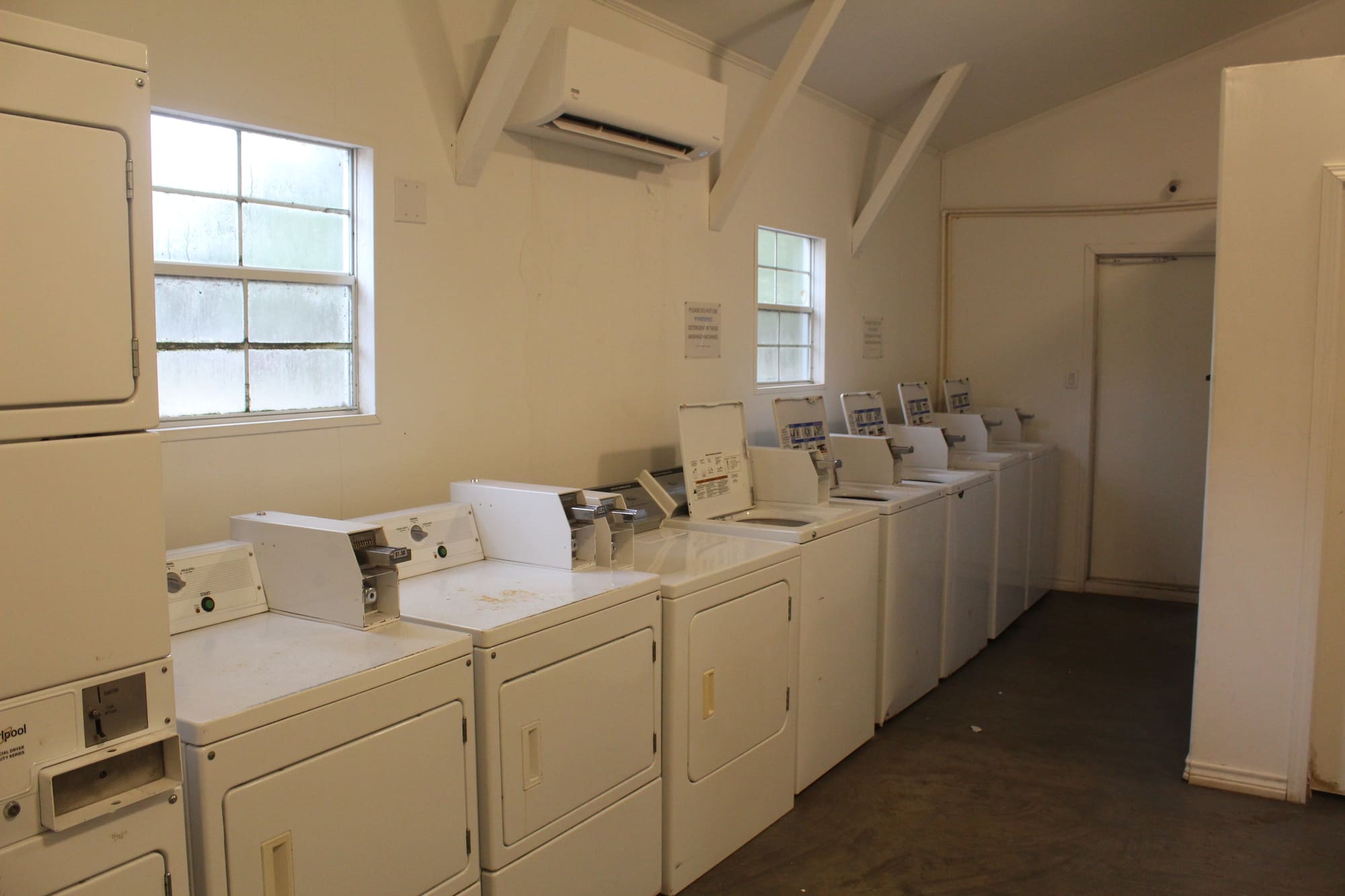 Coin laundry room with washers and dryers in the wash house at New Season RV Resort, Aransas Pass TX